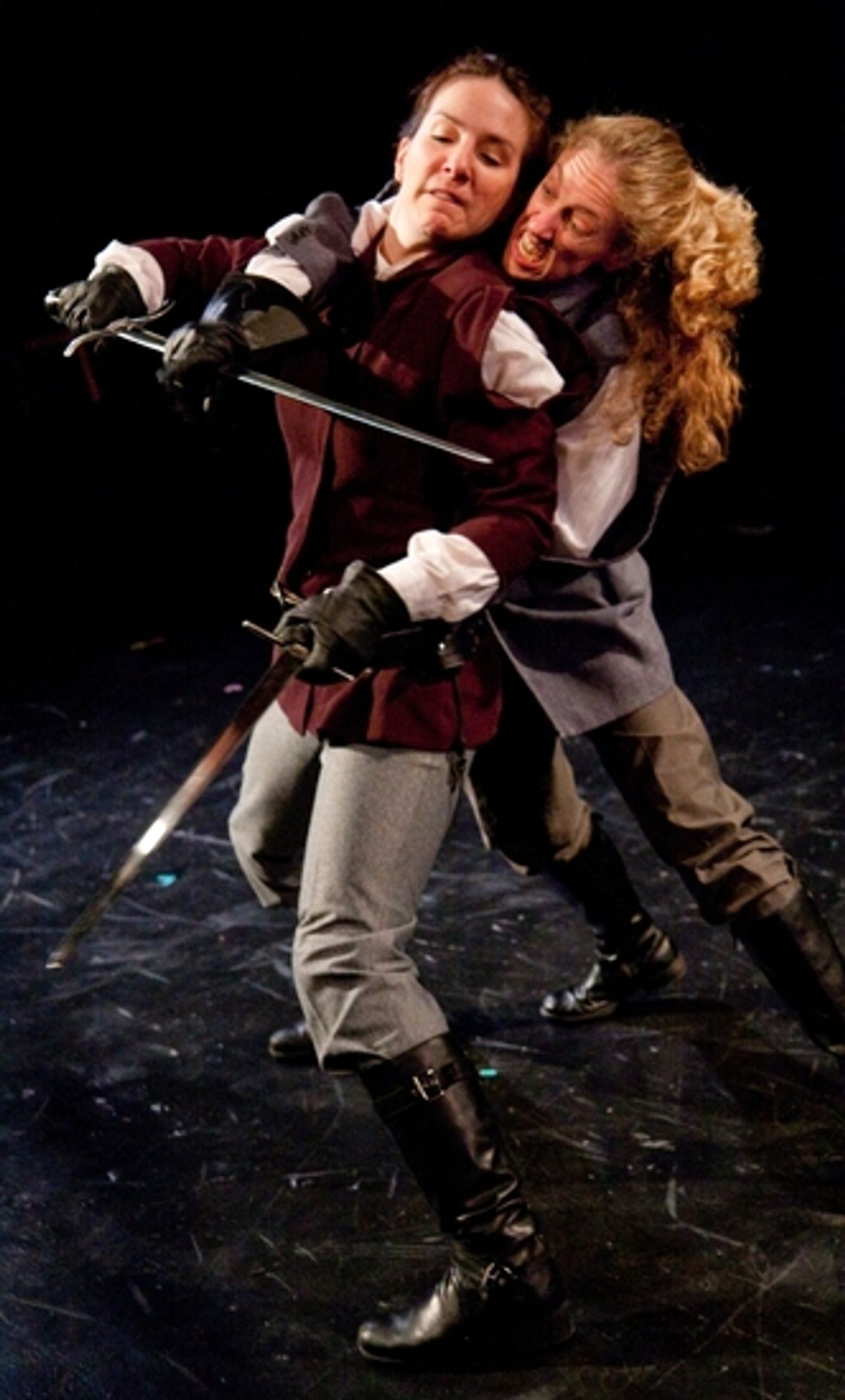 Macbeth (Kathrynne Wolf) defends herself from Macduff (Amy E. Harmon) at 